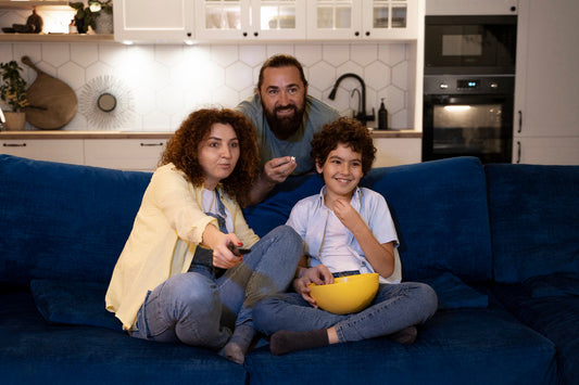 A family sitting comfortably on a sofa