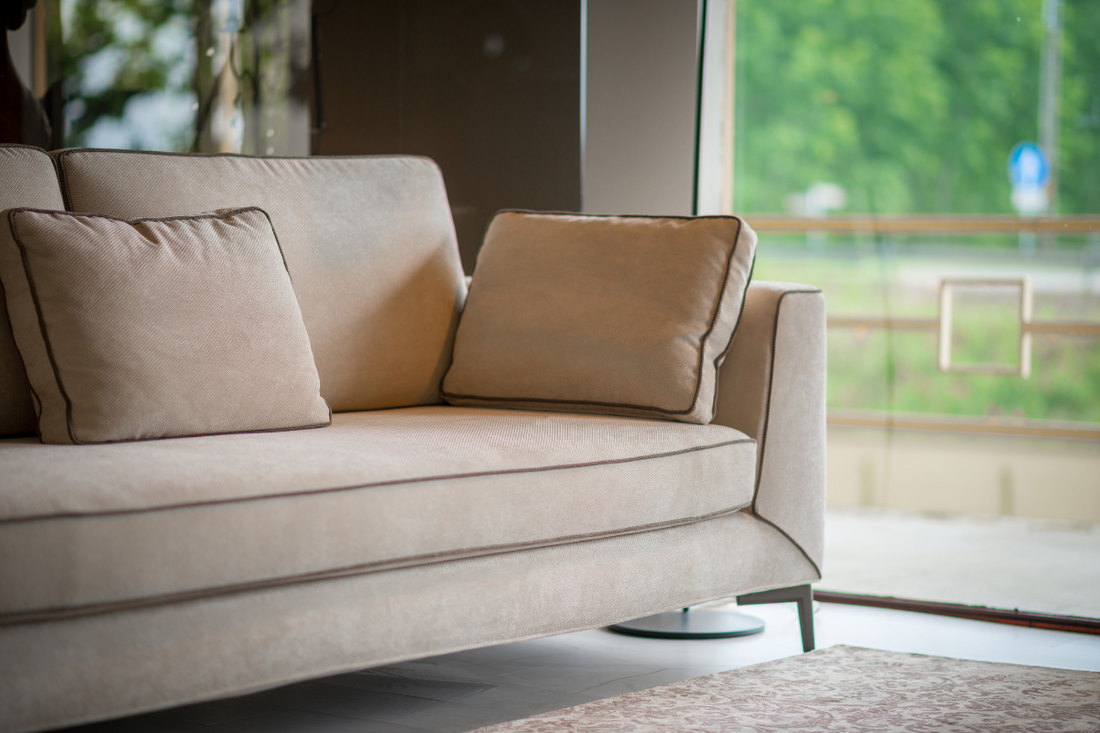 An elegant beige corduroy sofa with throw pillows